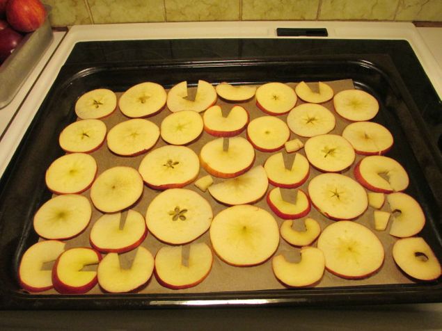En plåt med tre skivade äpplen som ska in i ugnen på 125 grader i ca 40 min och som blir jättegoda äpplechips som blir snabbt uppätna.